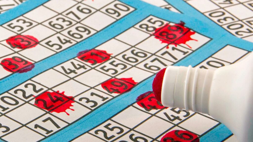 Blue and white bingo sheets marked with a red dabber used for gambling