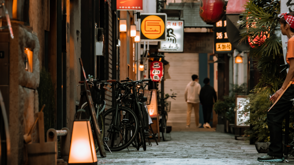 A narrow street with shop signs in Osaka, Japan.