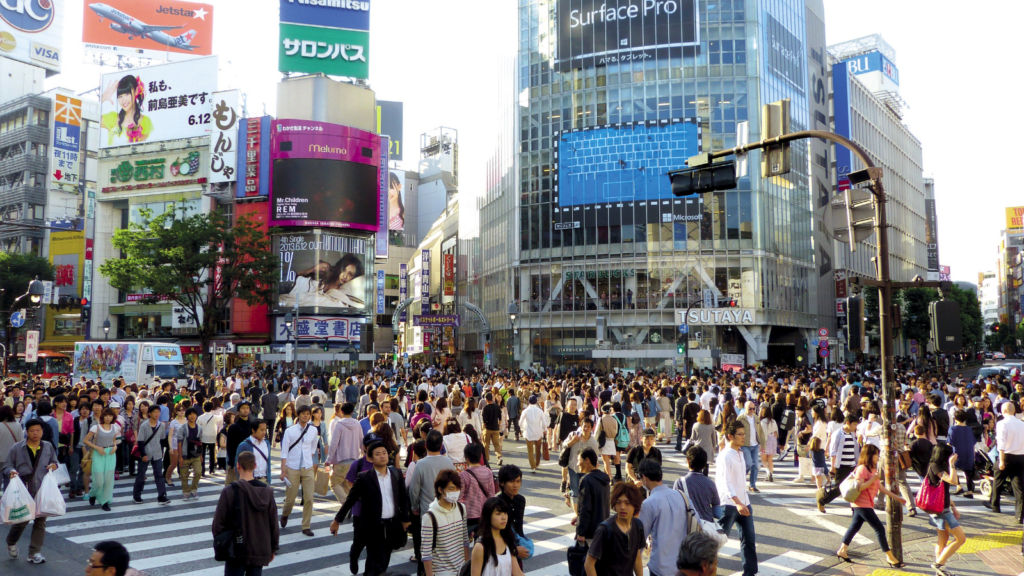 Crowds walking over a crossing in the centre of Tokyo, Japan.