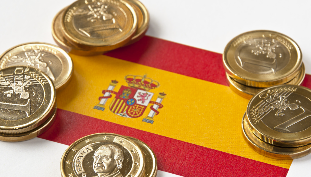 Spanish flag and euro coins.