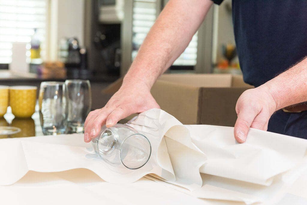 Training Manager wrapping glasses for a home move.